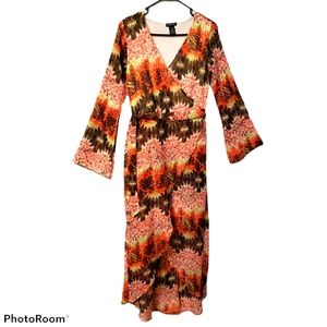 Norma Allen dress med featuring a vibrant orange and brown patterned print.